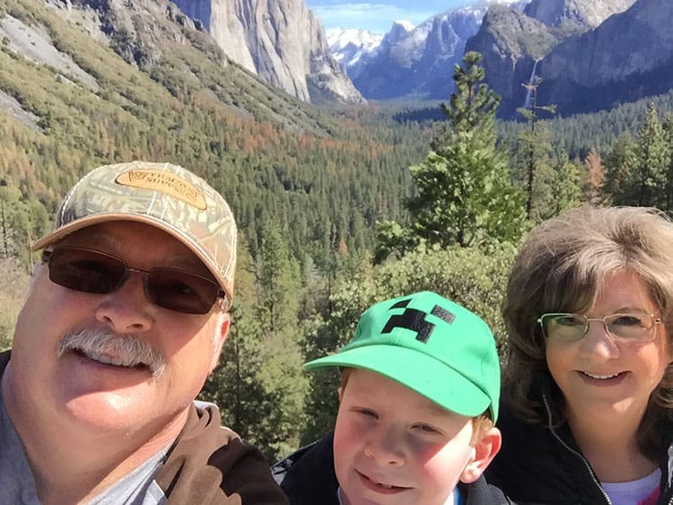 mom, dad and sun outdoors smiling