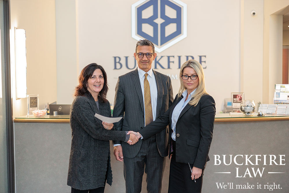 Buckfire Law Kalamazoo car accident attorneys with client