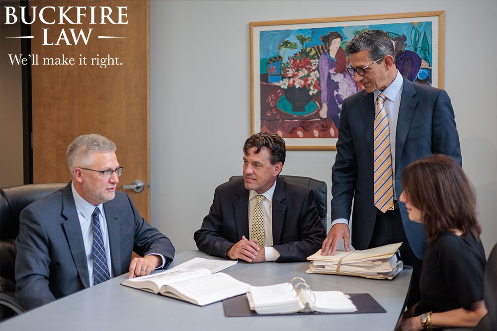 Buckfire Law t-bone car accident lawyers sitting around a table